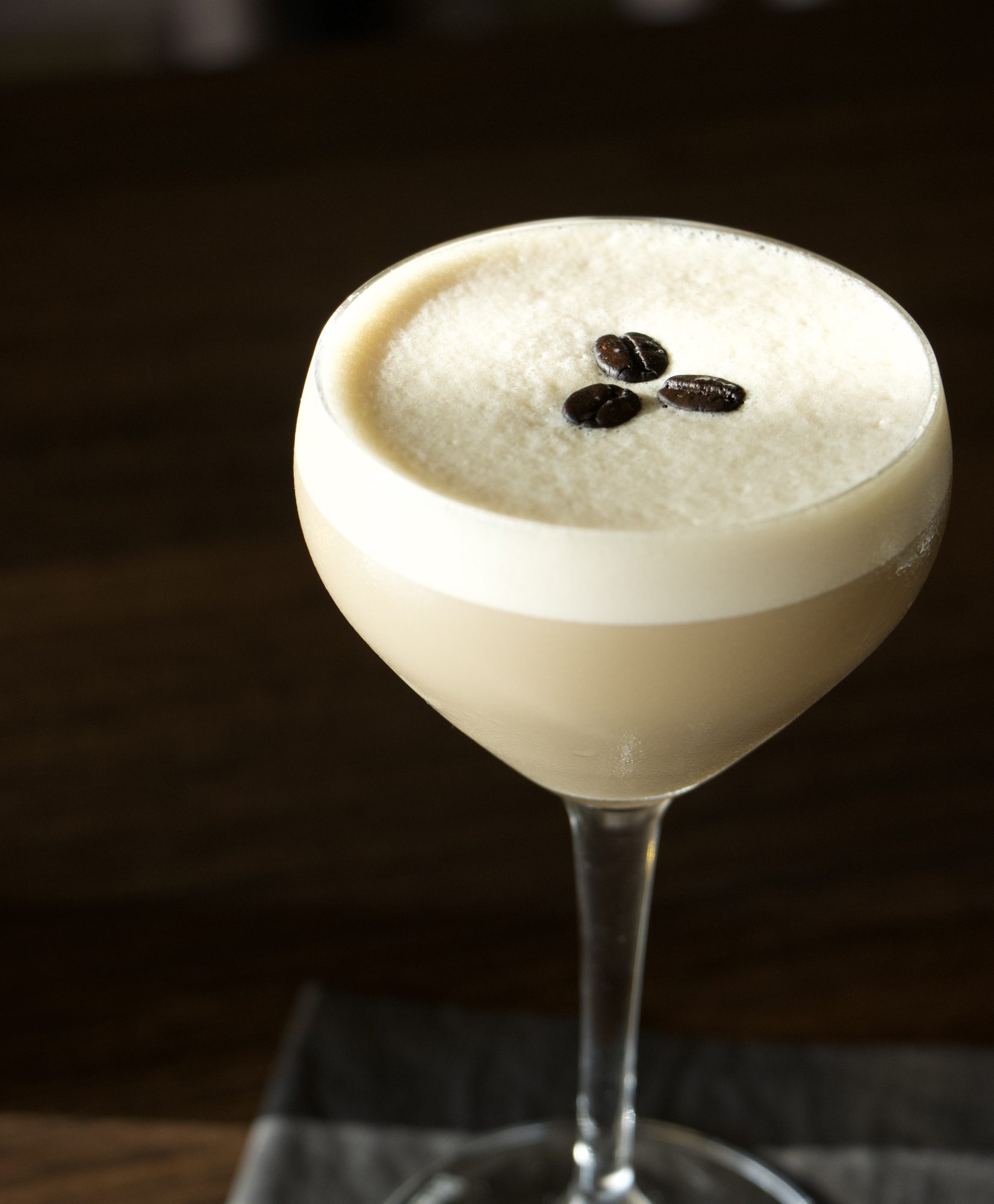 An espresso martini on the dark walnut bar at Danbi