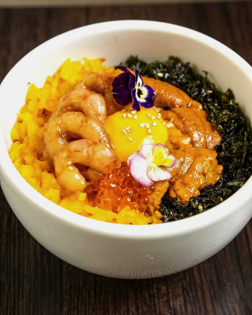 Uni bibimbap: cold uni, sweet shrimp, runny yolk and trout roe over warm rice